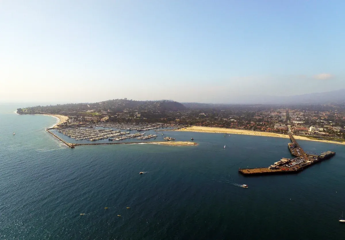 Panoramic aerial view of Santa Barbara Harbor Stearns Wharf and boats from a helicopter flight